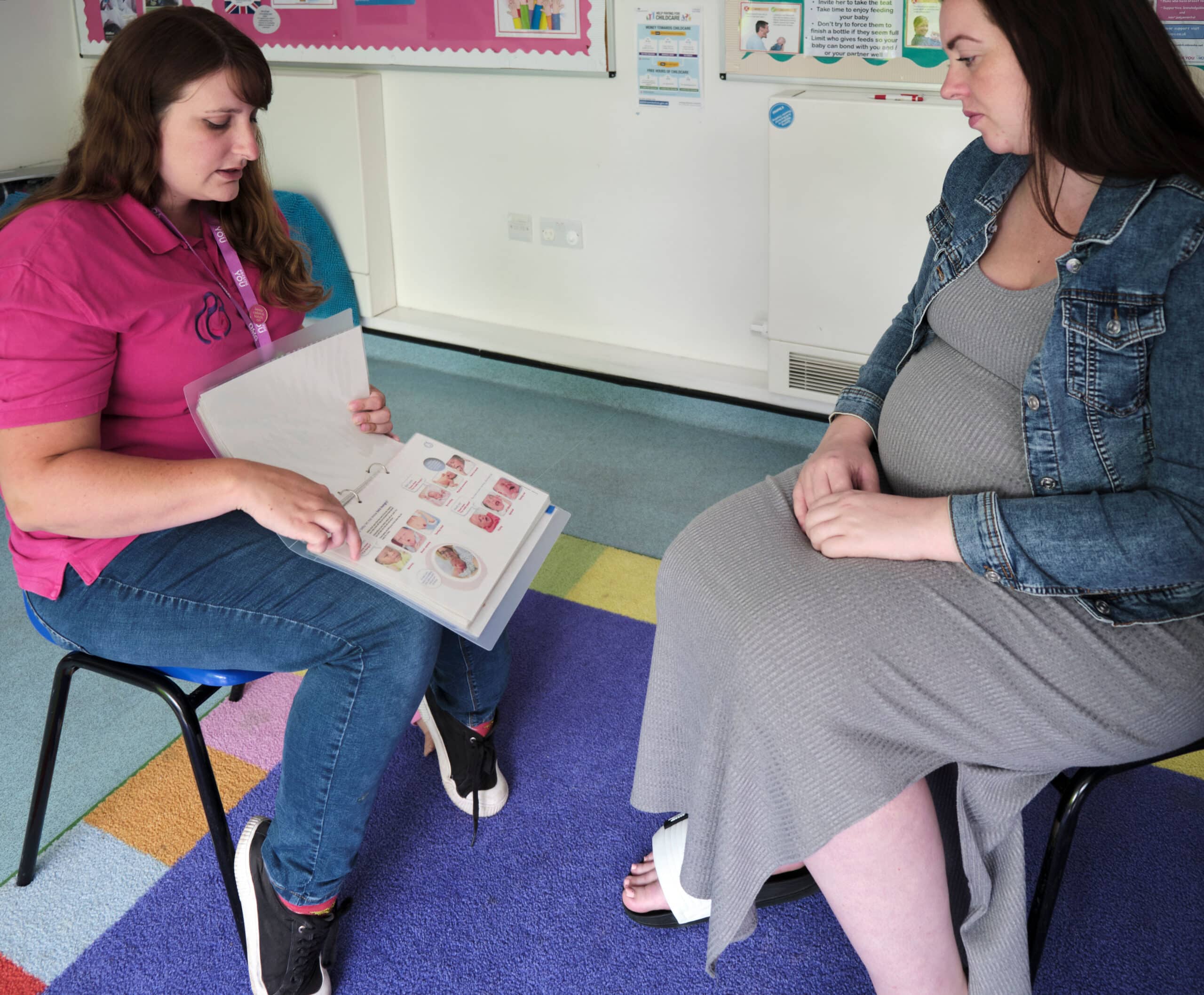 Pregnant mother getting support from a peer supporter